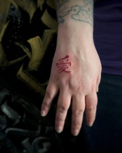 Tatuagem do Gaara com o kanji de amor na mão